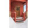 Charming red home entrance with winter wreath, lit with string lights at 186 Rachel Ln, Breckenridge, CO 80424