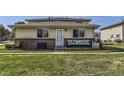 Front exterior of home with well-maintained lawn, vinyl siding and attractive front porch seating at 3225 S Garrison St # 9, Lakewood, CO 80227