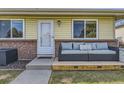 Inviting porch area with a comfortable outdoor sofa, creating a welcoming entrance to the home at 3225 S Garrison St # 9, Lakewood, CO 80227
