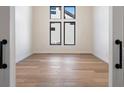 Bright, empty bedroom with hardwood floors and large windows offering plenty of natural light at 5741 Doc Bar Circle, Larkspur, CO 80118