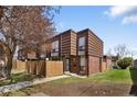 Attractive townhouse featuring brick facade, brown wood accents and a well-kept front lawn at 9338 W Utah Pl, Lakewood, CO 80232