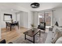 Inviting living room featuring an open floor plan, hardwood floors, and access to an outdoor patio at 9338 W Utah Pl, Lakewood, CO 80232