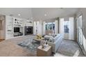 Spacious living room featuring a fireplace, built-in shelving, and large windows at 14032 E Chenango Dr, Aurora, CO 80015