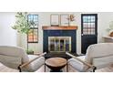 Cozy living area with a brick fireplace, stylish decor, and comfortable seating at 10310 E Jewell Ave # 57, Aurora, CO 80247