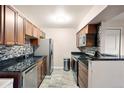 Modern kitchen with granite countertops and stainless steel appliances at 10150 E Virginia Ave # 2-205, Denver, CO 80247