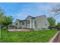 Relaxing backyard featuring a brick patio and lush greenery, perfect for outdoor entertaining at 5350 S Quail Way, Littleton, CO 80127