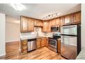 This kitchen features stainless steel appliances, granite countertops, updated lighting, and beautiful oak cabinets at 350 S Clinton St # 9B, Denver, CO 80247