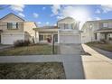 Inviting two-story home with a well-kept lawn and attached two-car garage at 5202 Cathay St, Denver, CO 80249