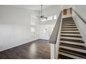 Bright living room with soaring ceilings, modern floors, and staircase at 5202 Cathay St, Denver, CO 80249