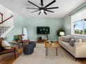 Cozy living room with hardwood floors, modern ceiling fan, and neutral color scheme at 800 Boulder Peak Ave, Erie, CO 80516