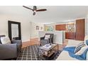 Cozy living room adjacent to the kitchen with hardwood floors and comfortable seating at 10844 W 68Th Ave, Arvada, CO 80004