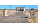 Two-story home with an attached three car garage, and a long private driveway at 8700 Lost Lake Dr, Franktown, CO 80116