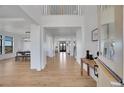 Bright, spacious foyer features hardwood flooring, large windows, and an open floor plan leading to the living spaces at 8700 Lost Lake Dr, Franktown, CO 80116