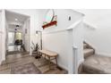 Inviting entryway featuring modern decor, a charming bench and access to the staircase with natural light at 509 High Point Dr, Longmont, CO 80504