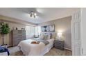 Comfortable bedroom with large window, dresser, and nightstands at 11813 Bellaire Cir, Thornton, CO 80233