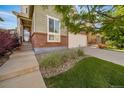 Charming two-story home with landscaped yard, sidewalk, driveway and a two car garage at 14035 Touchstone St, Parker, CO 80134