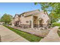 Beautiful exterior view of townhome with well-kept landscaping, rock accents, and inviting outdoor seating at 1601 Great Western Dr # D3, Longmont, CO 80501