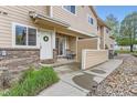 Inviting front porch with table and chairs, leading to a well-maintained townhome exterior at 1601 Great Western Dr # D3, Longmont, CO 80501