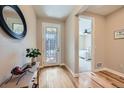 Bright foyer featuring hardwood floors, decorative mirror, console table and view to a bedroom at 3325 Yale Dr, Broomfield, CO 80023