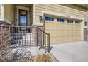 Exterior of a house featuring a front door with windows, stone accents, and a two-car garage at 3325 Yale Dr, Broomfield, CO 80023