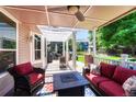 Relax on this covered patio featuring comfortable seating and a cozy fire pit table at 10142 Mountain Maple Dr, Highlands Ranch, CO 80129