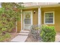 Welcoming front entrance featuring well maintained steps, a security door and a manicured shrub at 14129 E Dickinson Dr # D, Aurora, CO 80014