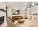 Bright living room featuring wood floors, modern decor, and a cozy fireplace at 14129 E Dickinson Dr # D, Aurora, CO 80014