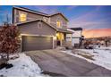 Two-story house with gray siding, attached garage, and front porch, dusk at 2633 Garganey Dr, Castle Rock, CO 80104