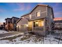 Two-story house with gray siding, attached garage, and front porch, dusk at 2633 Garganey Dr, Castle Rock, CO 80104