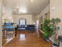 Spacious living room with hardwood floors, stone fireplace, and large windows for natural light at 5175 Quari St, Denver, CO 80239