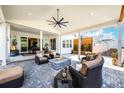 Covered outdoor patio area features an inviting seating area, ceiling fan and outdoor decor at 5707 Cadara Way, Parker, CO 80134