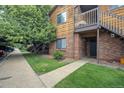 Inviting condominium with a well-maintained lawn and classic wood and brick facade at 2237 S Buckley Rd # 101, Aurora, CO 80013