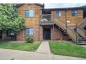 Inviting condominium with a well-maintained lawn and classic wood and brick facade at 2237 S Buckley Rd # 101, Aurora, CO 80013