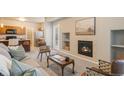Living room with fireplace, kitchen view, and comfortable seating at 16911 Buffalo Valley Path, Monument, CO 80132
