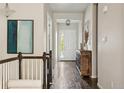 Bright hallway features dark hardwood floors, elegant decor, and plenty of natural light from the front door at 10929 Endeavor Dr, Parker, CO 80134