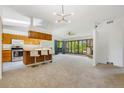 Open-concept living space featuring a breakfast bar, large windows and natural lighting at 12771 W 6Th Pl, Lakewood, CO 80401