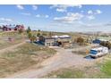Exterior home with barn, red house, RV, and hillside landscape at 40192 Margaret Dr, Elizabeth, CO 80107