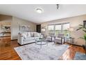 Inviting living room featuring a plush sofa, chairs, bay window, hardwood floors and stylish decor at 40192 Margaret Dr, Elizabeth, CO 80107