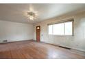 Bright living room featuring hardwood floors and a front entrance at 1335 Locust St, Denver, CO 80220