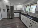 Kitchen featuring stainless steel appliances, white cabinets, and black countertops at 8947 Rutgers St, Westminster, CO 80031
