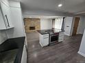 Open-concept kitchen with a central island and stainless steel appliances opens to the living room at 8947 Rutgers St, Westminster, CO 80031