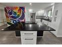 Bright kitchen featuring stainless steel appliances, white cabinets and a large center island at 8947 Rutgers St, Westminster, CO 80031