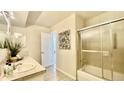 Bathroom featuring a shower-tub combo and a framed floral print at 7695 E Quincy Ave # 207, Denver, CO 80237
