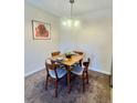 Cozy dining area with a square table, seating for four, and overhead lighting at 7695 E Quincy Ave # 207, Denver, CO 80237