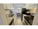 Well-maintained kitchen with appliances; open to the dining area at 7695 E Quincy Ave # 207, Denver, CO 80237