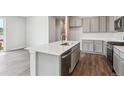 Bright kitchen island with stainless appliances and quartz counters provides a gathering spot at 14145 Deertrack Ln, Parker, CO 80134