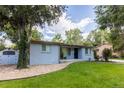 Inviting single-story home with a well-manicured lawn, mature trees, and a shed in a serene neighborhood at 7650 W 24Th Ave, Lakewood, CO 80214