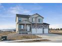 Charming two-story home with a three-car garage, stone accents and covered porch at 4204 Sandstone Dr, Mead, CO 80504