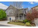 Beautiful gray two-story house featuring well-manicured lawn and covered porch, and attached garage at 1867 W 137Th Ln, Broomfield, CO 80023