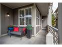 Inviting covered porch with comfortable seating, decorative planters, and stylish outdoor lighting fixtures at 1867 W 137Th Ln, Broomfield, CO 80023